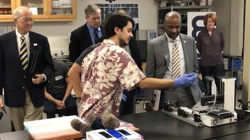 Undergraduate student shares their bioprinter prototype with Chancellor May.